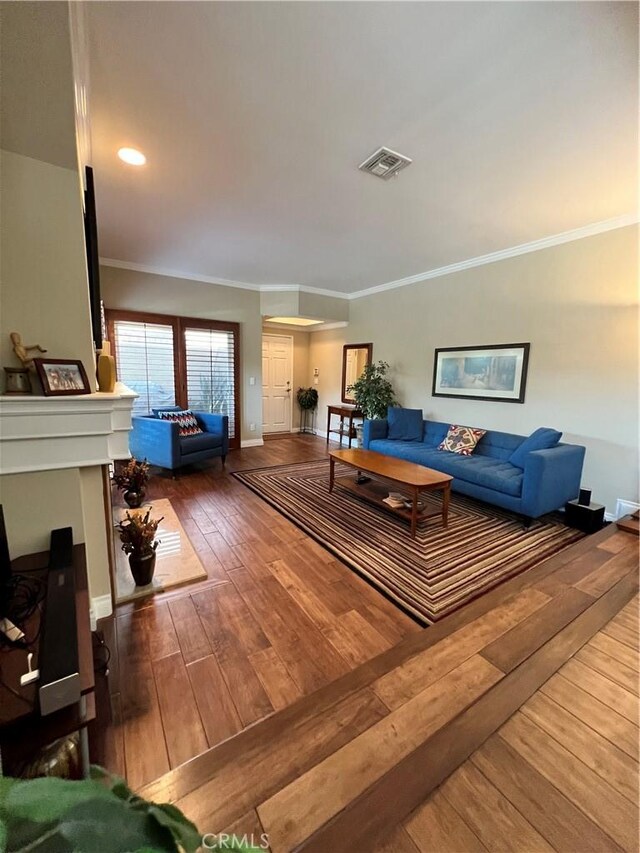 living room with ornamental molding and hardwood / wood-style flooring