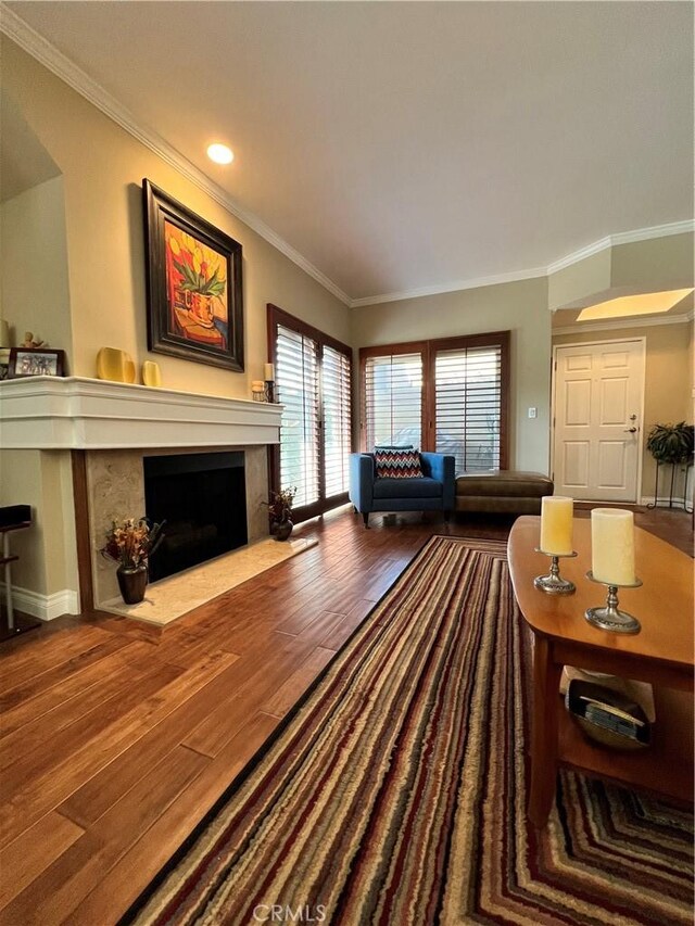 living room featuring wood-type flooring and crown molding