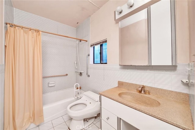 full bathroom with tile patterned floors, shower / bath combination with curtain, toilet, vanity, and tile walls