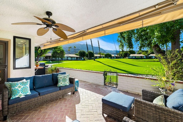 view of patio / terrace with a mountain view, outdoor lounge area, and ceiling fan