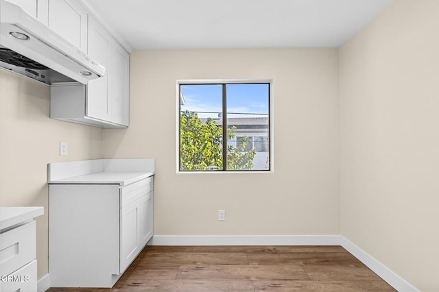 laundry area with light hardwood / wood-style floors