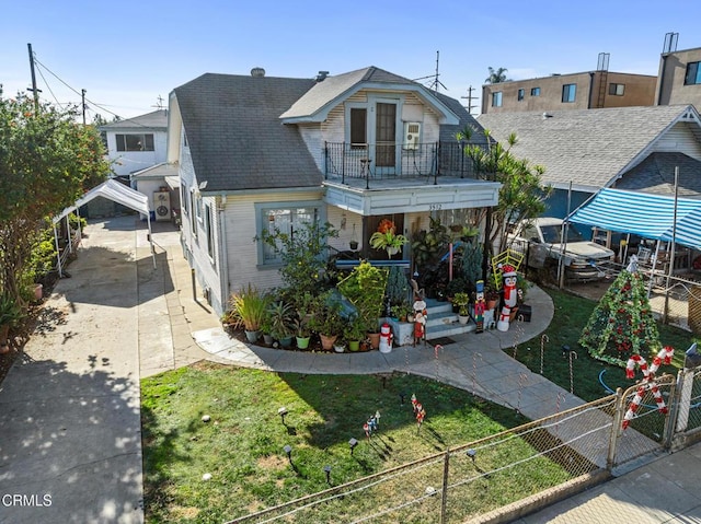 view of front of property with a balcony and a front yard