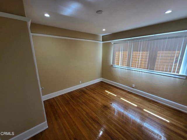 unfurnished room with wood-type flooring