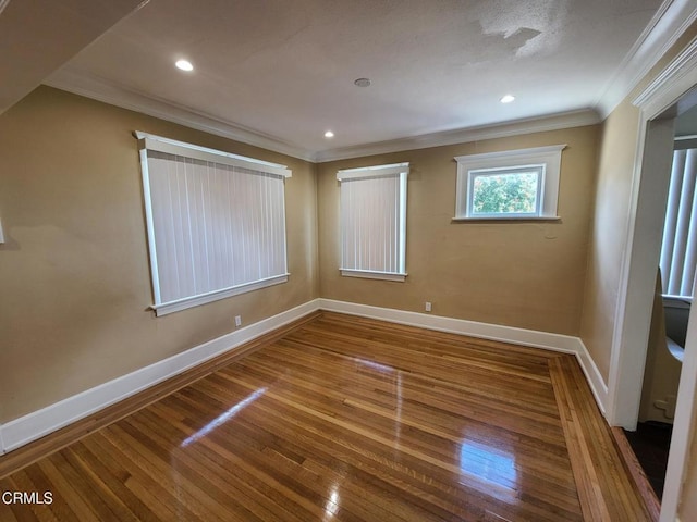 unfurnished room featuring wood-type flooring and crown molding