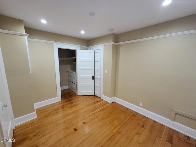 unfurnished bedroom featuring light wood-type flooring and a closet