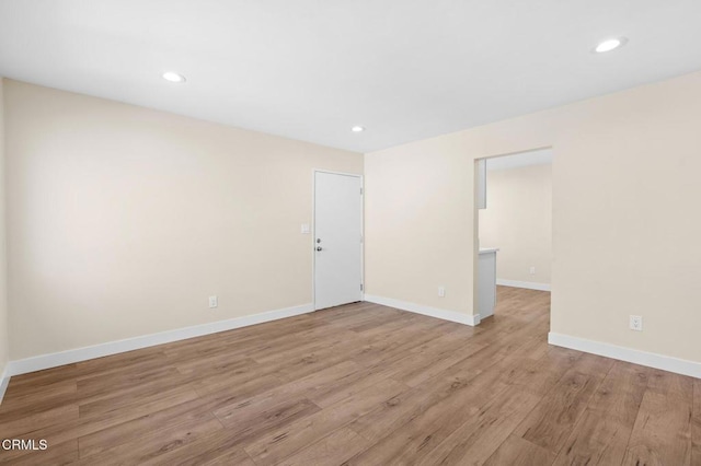 empty room with light hardwood / wood-style flooring