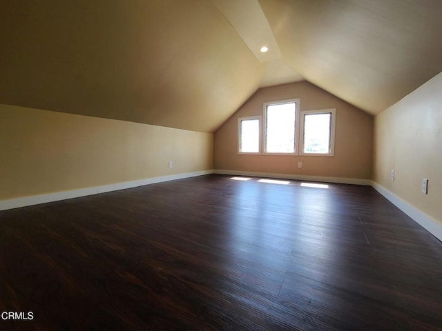 bonus room featuring dark hardwood / wood-style flooring and vaulted ceiling