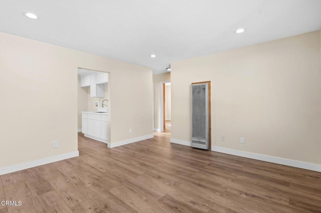 unfurnished room with light hardwood / wood-style floors