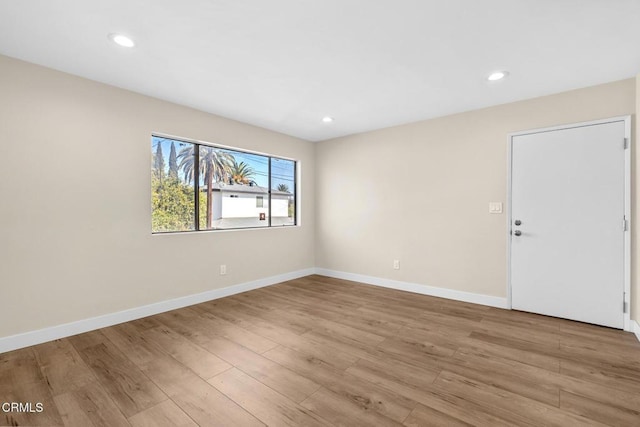 unfurnished room with light hardwood / wood-style floors