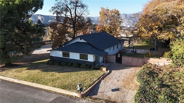 exterior space featuring a front yard and a mountain view