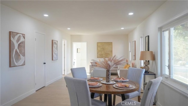 dining space with plenty of natural light and light wood-type flooring