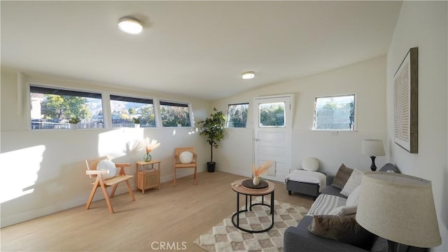 sitting room with light hardwood / wood-style floors, a wealth of natural light, and lofted ceiling