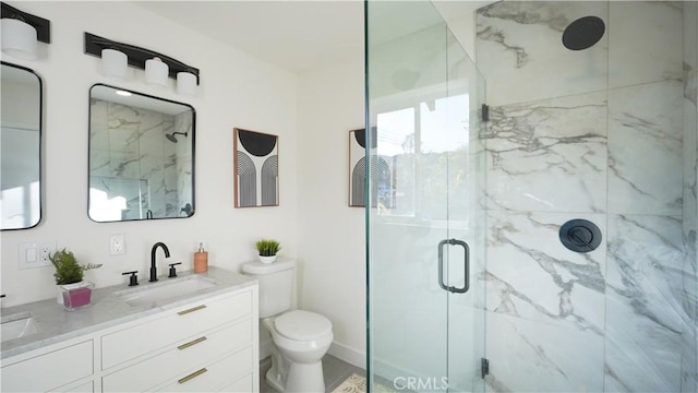 bathroom with walk in shower, vanity, and toilet