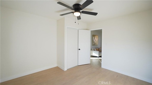 empty room featuring ceiling fan and light wood-type flooring