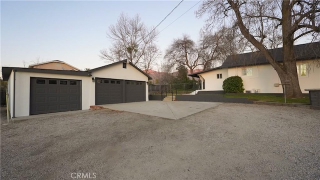 property exterior at dusk featuring a garage