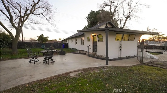 view of side of home featuring a patio area and a yard