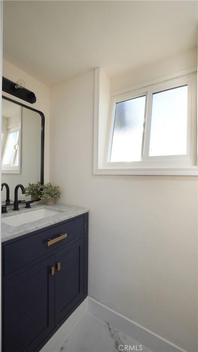 bathroom featuring a healthy amount of sunlight and vanity