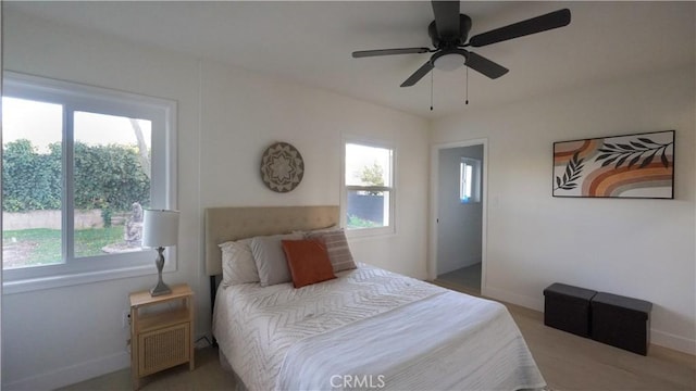 bedroom with ceiling fan and multiple windows