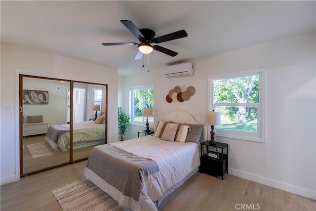35414 Date Ave, Yucaipa, CA 92399 - bedroom with an AC wall unit, light wood finished floors, a ceiling fan, and a closet
