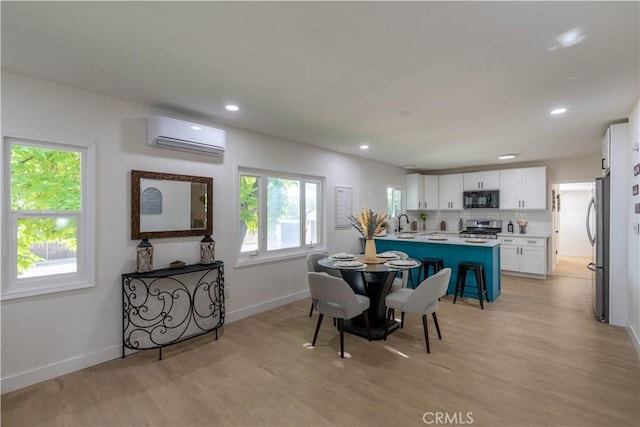 35414 Date Ave, Yucaipa, CA 92399 - dining area featuring light wood-type flooring, a wall mounted AC, and recessed lighting