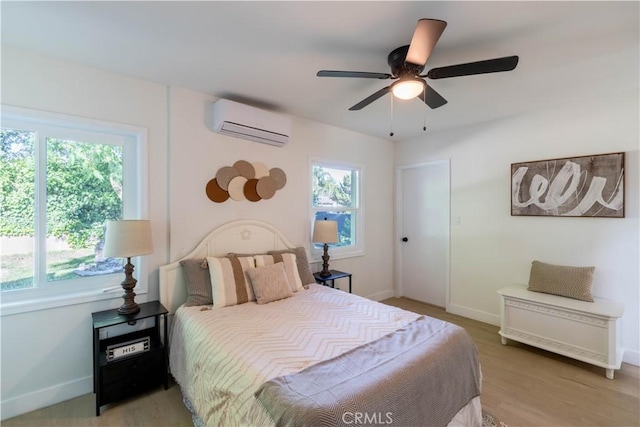 35414 Date Ave, Yucaipa, CA 92399 - bedroom featuring a wall unit AC, ceiling fan, and light wood-style flooring