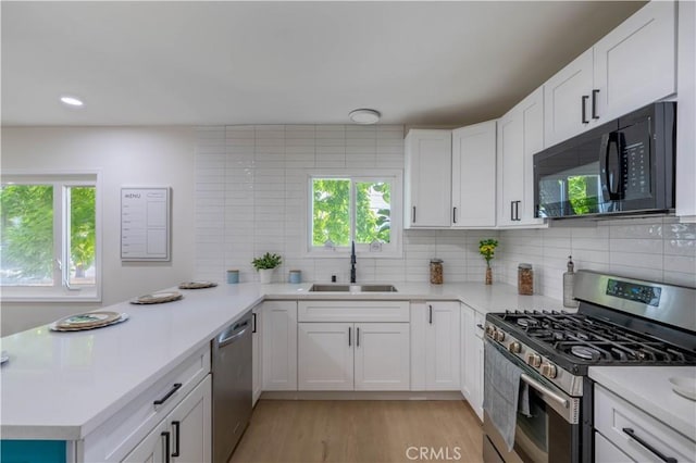35414 Date Ave, Yucaipa, CA 92399 - kitchen with stainless steel appliances, light countertops, decorative backsplash, a peninsula, and recessed lighting