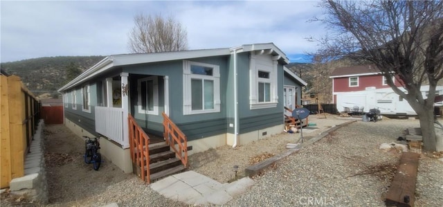 view of front facade featuring crawl space and fence