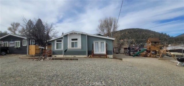 back of house with a mountain view and french doors