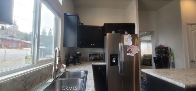 kitchen with sink, plenty of natural light, carpet, and appliances with stainless steel finishes