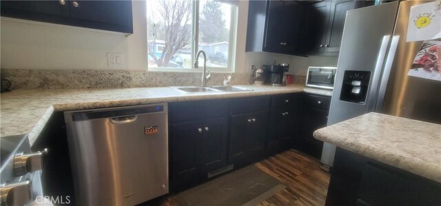 kitchen with dark hardwood / wood-style floors, sink, and stainless steel appliances