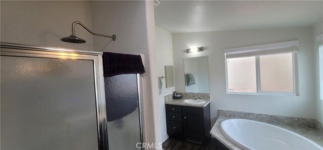 bathroom featuring vanity, lofted ceiling, and independent shower and bath