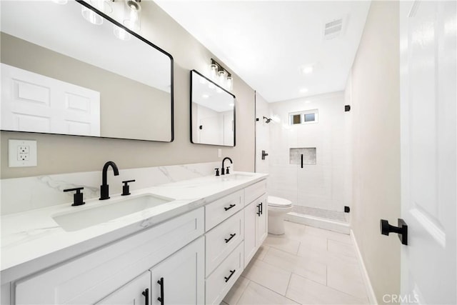 bathroom featuring tile patterned flooring, vanity, toilet, and walk in shower