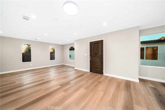 spare room featuring light wood-type flooring