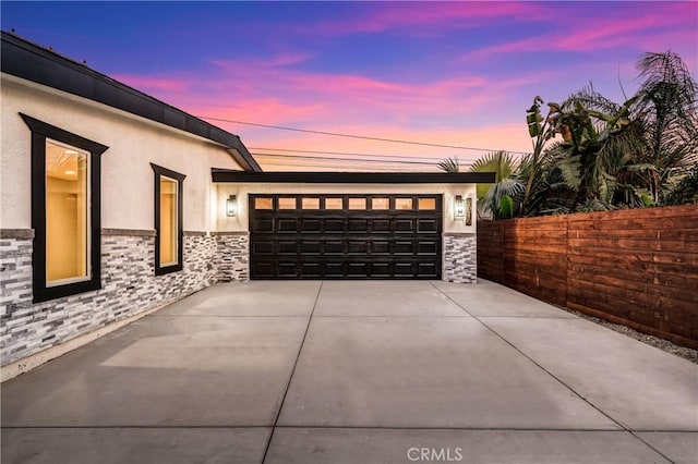 view of garage at dusk