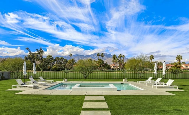 view of swimming pool featuring a lawn, a patio area, and a mountain view