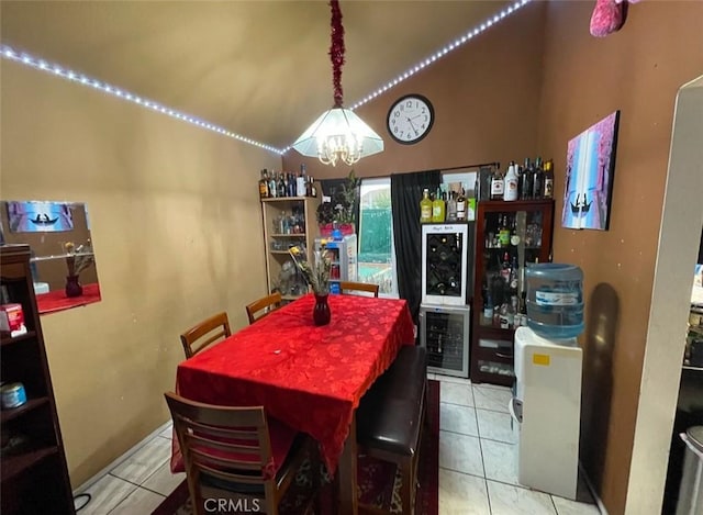 dining area with light tile patterned floors, an inviting chandelier, and wine cooler