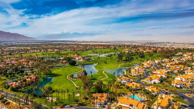 birds eye view of property with a water and mountain view