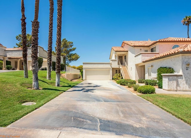 mediterranean / spanish-style home featuring a front yard