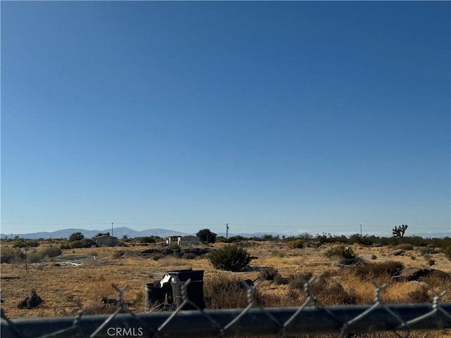 view of yard with a mountain view and a rural view