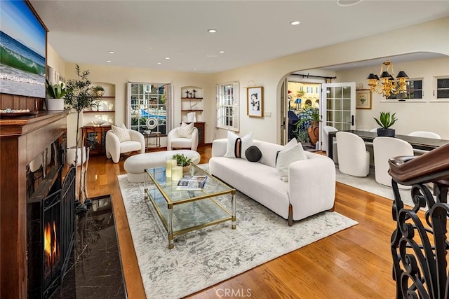 living room with hardwood / wood-style floors and a notable chandelier