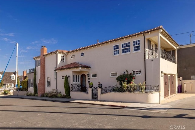 mediterranean / spanish-style home with a garage