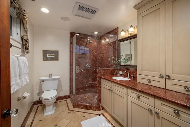 bathroom with vanity, toilet, and an enclosed shower