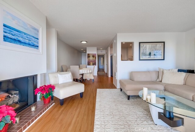 living room featuring wood-type flooring and a textured ceiling