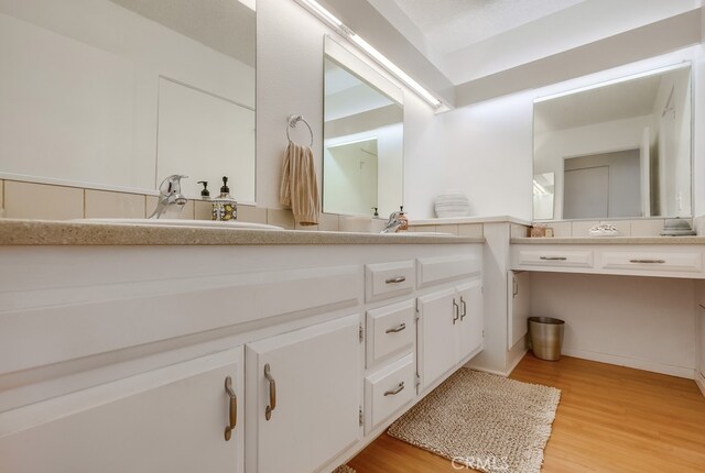 bathroom featuring hardwood / wood-style flooring and vanity