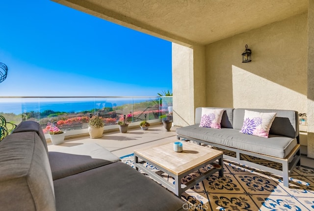 view of patio with an outdoor living space and a balcony