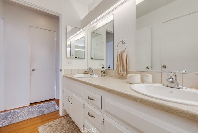 bathroom with vanity and hardwood / wood-style flooring