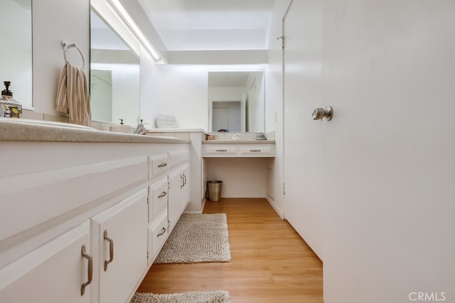 bathroom with vanity and hardwood / wood-style floors