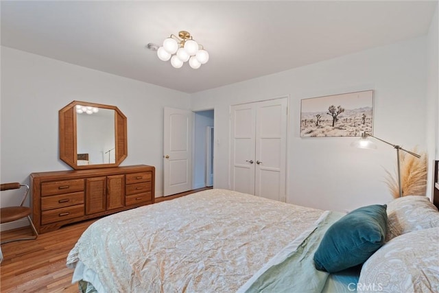 bedroom with a closet and light hardwood / wood-style flooring