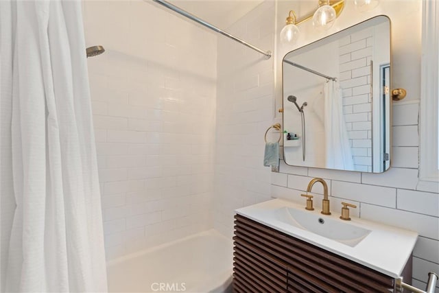 bathroom with vanity, backsplash, tile walls, and shower / bath combo with shower curtain