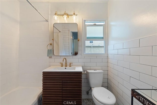 full bathroom with vanity, toilet, shower / washtub combination, and tile walls